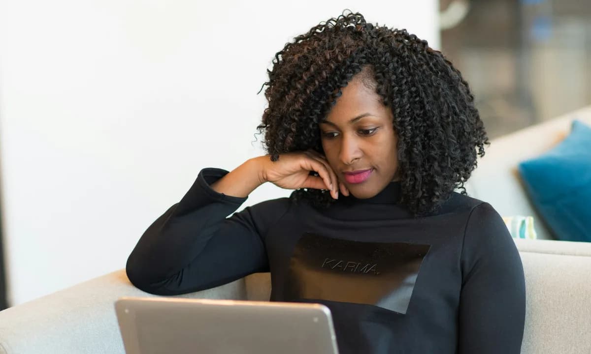 Consultant working on a laptop in a bright office